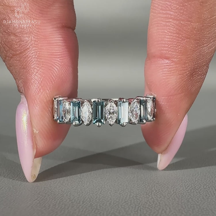 Blue baguette diamond wedding band crafted in white gold with prong setting.
