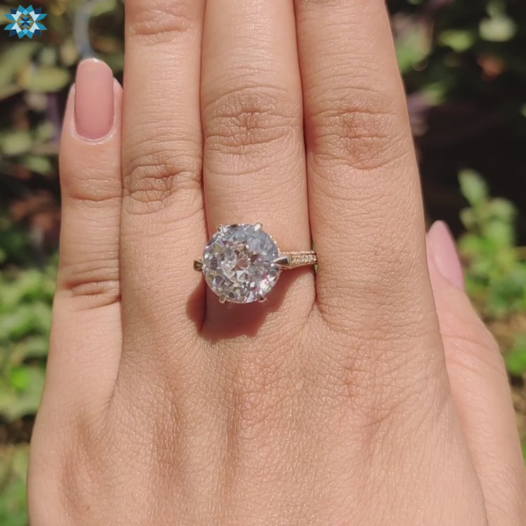 Round cut hidden halo setting on yellow gold band.
