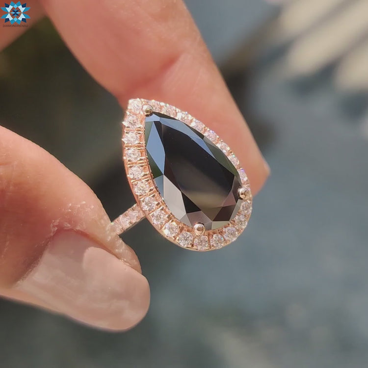 Rose gold engagement ring featuring pear-shaped black moissanite centre stone.

