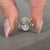 Handmade oval diamond ring with marquise and round stones.