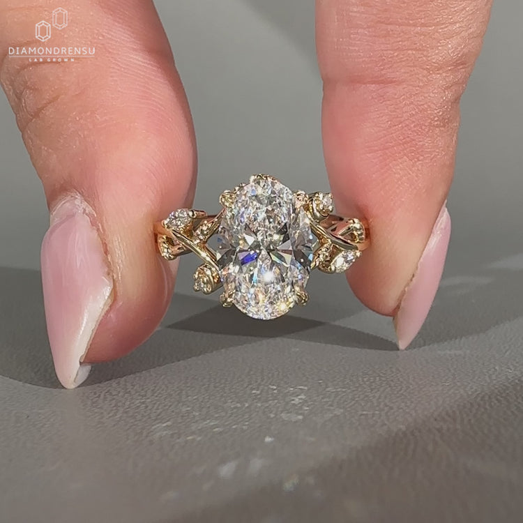 Handmade oval diamond ring with marquise and round stones.