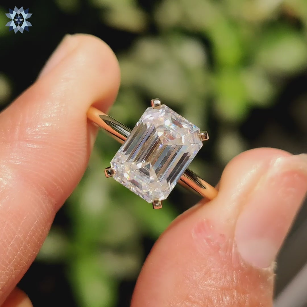 Hidden halo engagement ring featuring a solitaire design and tab prong setting.
