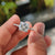 Radiant Rensu cut moissanite ring with white gold and pave band.
