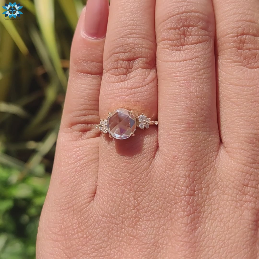 Muse setting ring featuring moissanite centre and round side stones.
