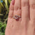 Muse setting ring featuring moissanite centre and round side stones.

