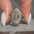 Marquise cut diamond ring with round side stones.