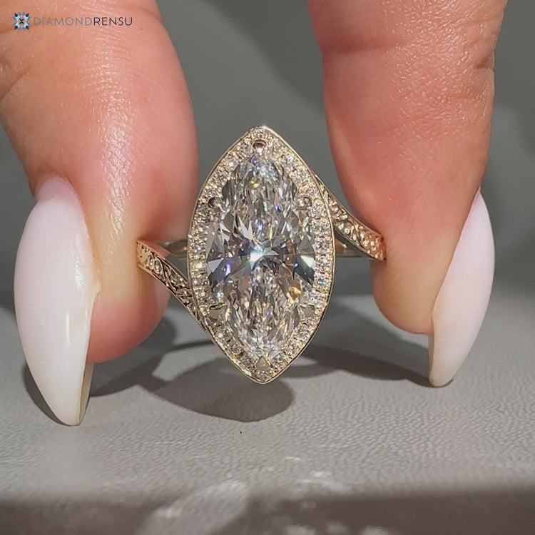Marquise cut diamond ring with round side stones.