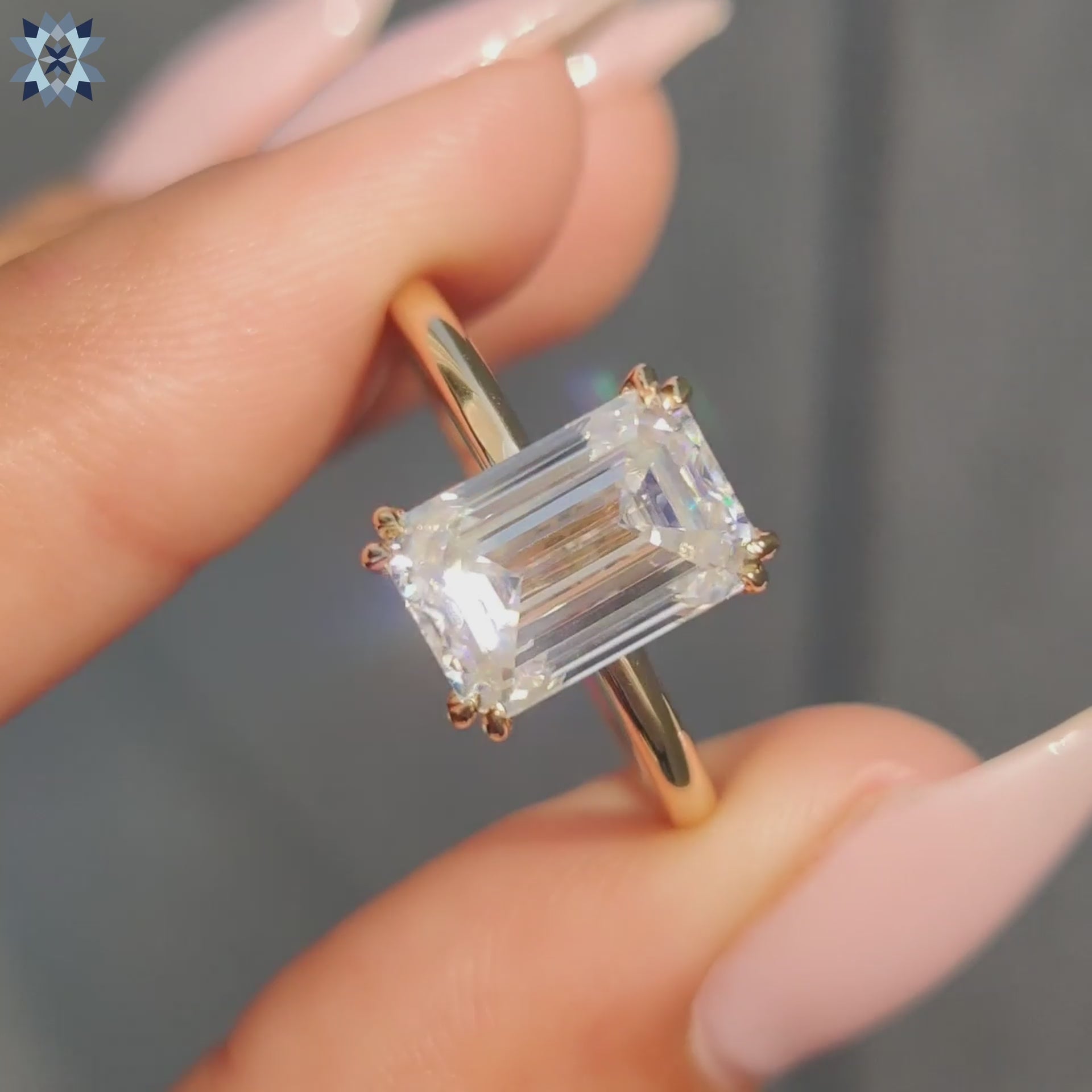 Solitaire setting ring featuring emerald cut moissanite and handmade band.
