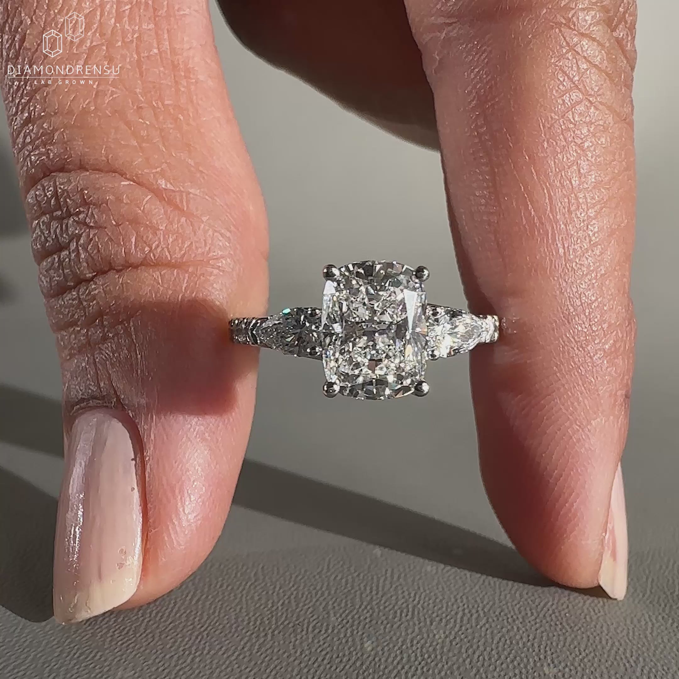 Cushion diamond ring in side stone engagement ring style
