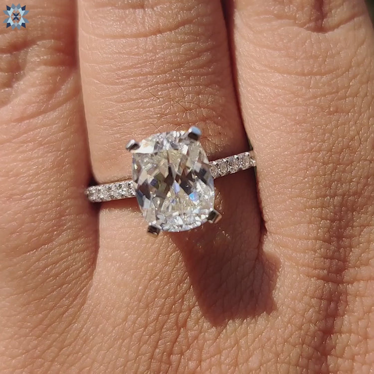 Cushion moissanite ring with secure 4 tab prong setting.
