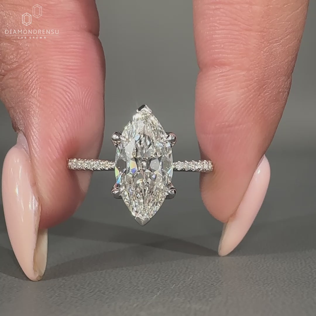 Round cut pave ring featuring claw prong and V shaped prong details.

