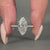 Round cut pave ring featuring claw prong and V shaped prong details.
