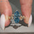 Blue centre diamond ring with hidden round diamonds