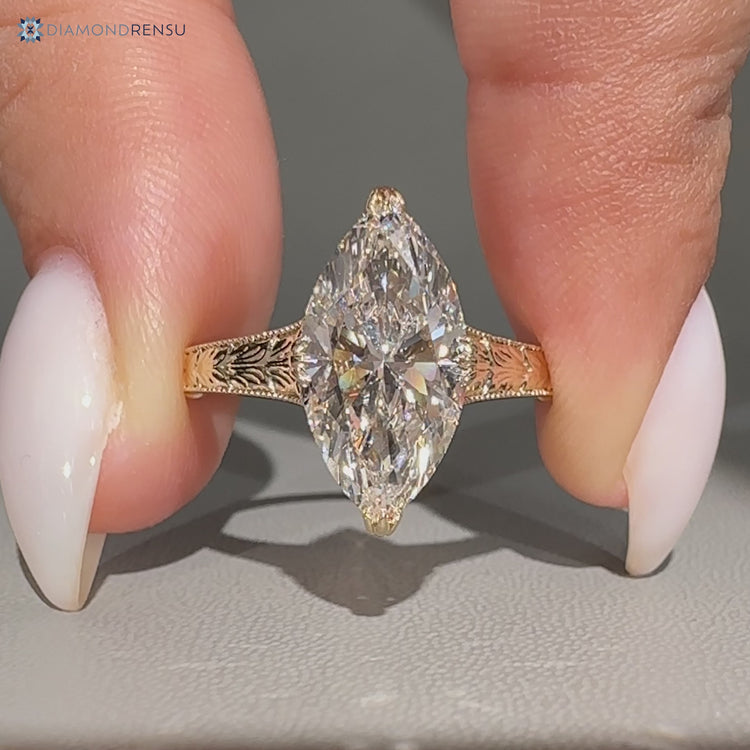 Vintage style marquise diamond ring with milgrain details.