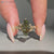 Green diamond ring with nature inspired style and tulip setting.