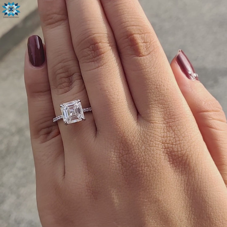 Classic Asscher cut custom Moissanite ring with pave band and claw prongs.
