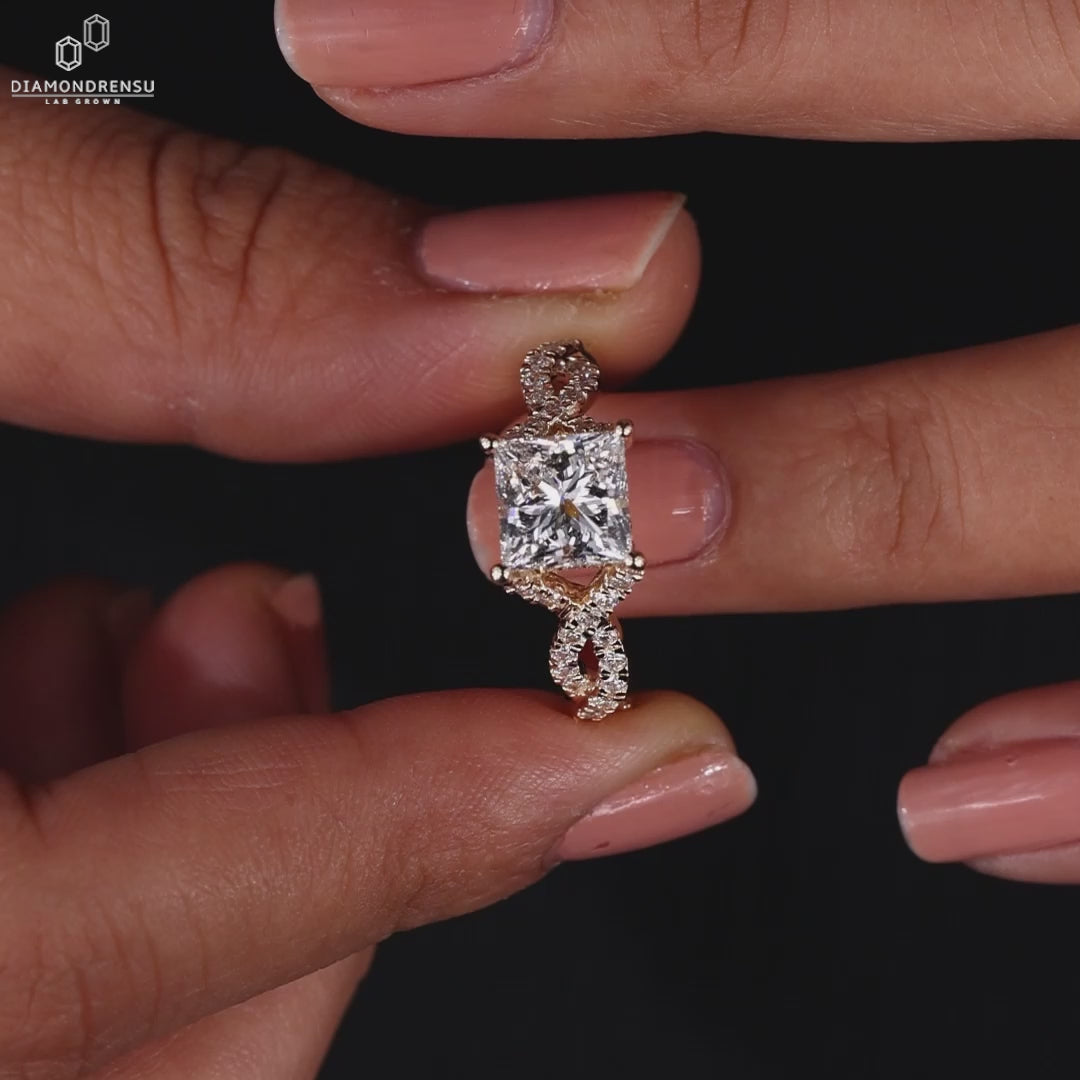 Princess cut ring includes hidden halo engagement ring design.
