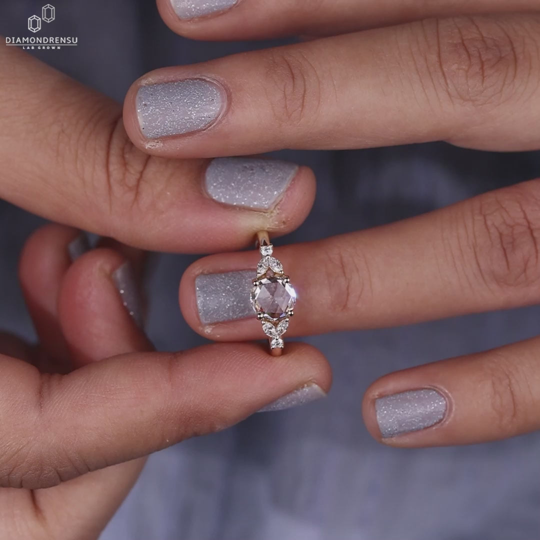 A model showcasing a beautiful rose cut diamond ring on her finger.