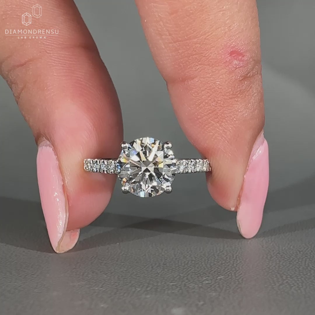 Round diamond ring with pave setting and cathedral design