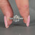 Round diamond ring with pave setting and cathedral design