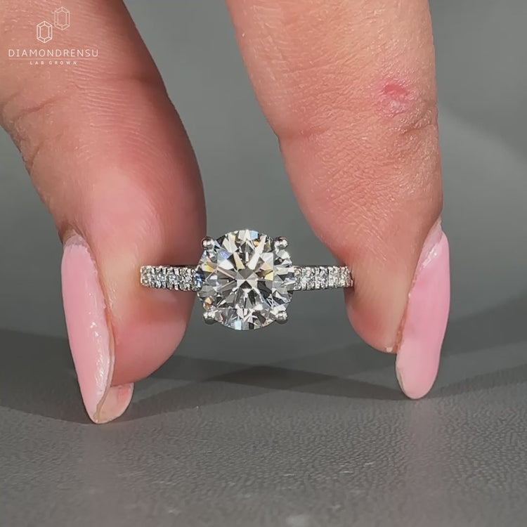 Round diamond ring with pave setting and cathedral design