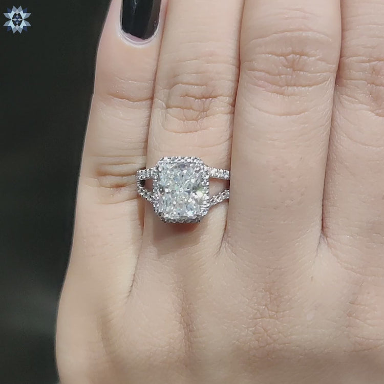 Moissanite halo ring with radiant cut stone in gold.
