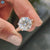 Twisted band solitaire ring crafted with round cut moissanite centre.
