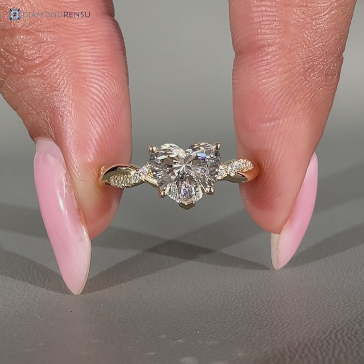 Heart cut diamond ring with twisted shank and prong setting.