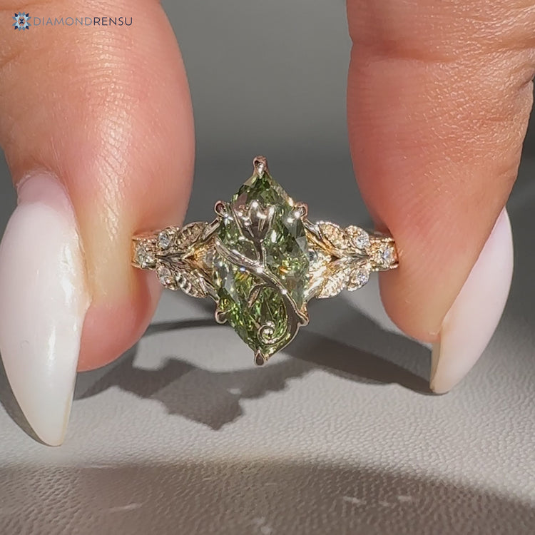 Green centre diamond ring with tulip setting and split shank.