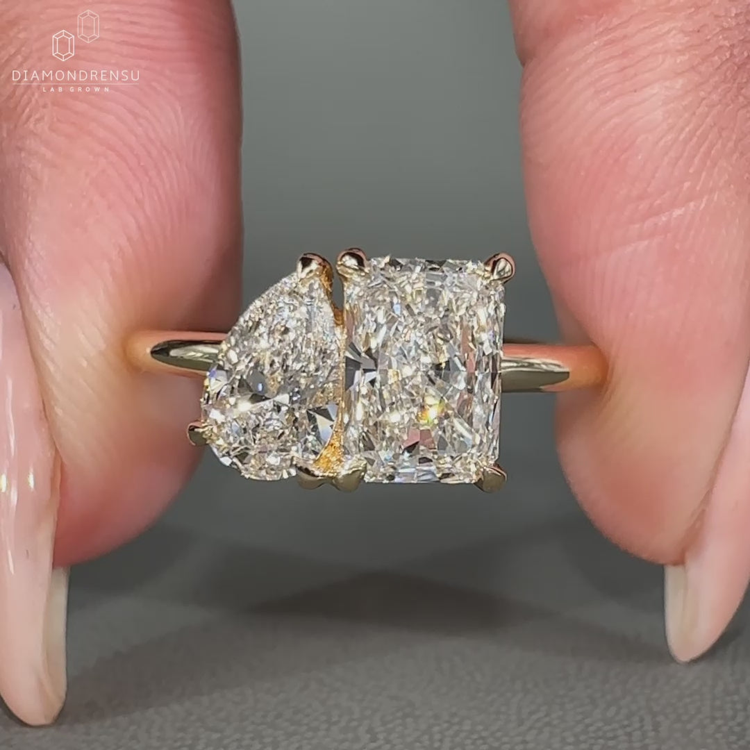 Pear Cut Diamond set with radiant diamond in claw prong setting.