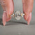Gold oval diamond engagement ring with a hidden halo design.

