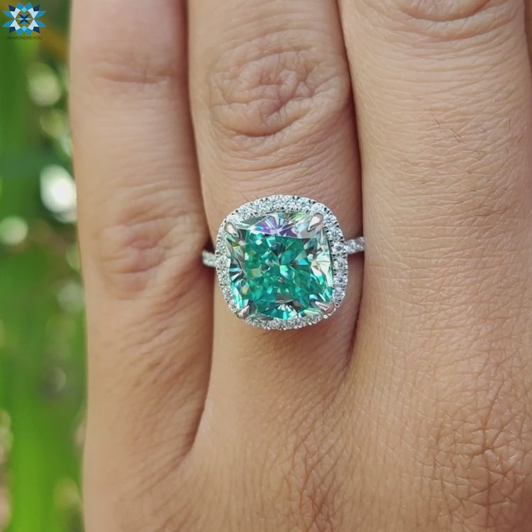 White gold moissanite ring with round pave stones and cyan cushion centre from Diamondrensu UK.
