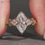 Marquise diamond ring with muse setting and side stones.
