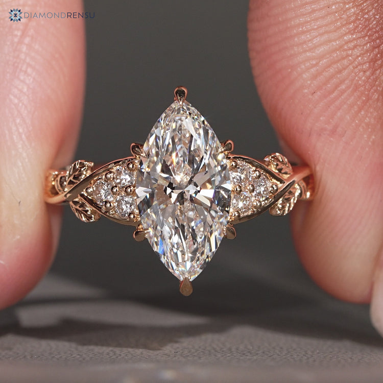 Marquise diamond ring with muse setting and side stones.