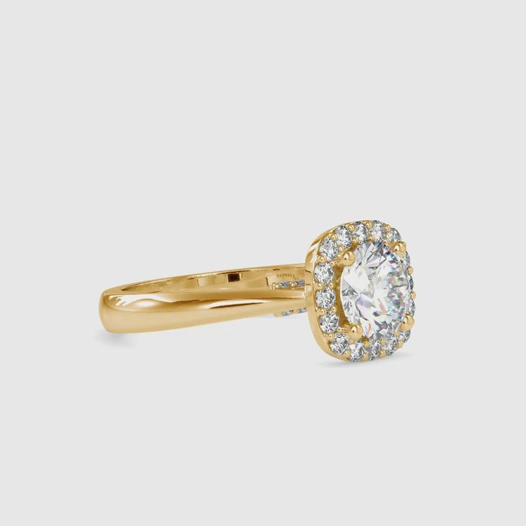Diamondrensu UK ring featuring round cut halo and gold shank.
