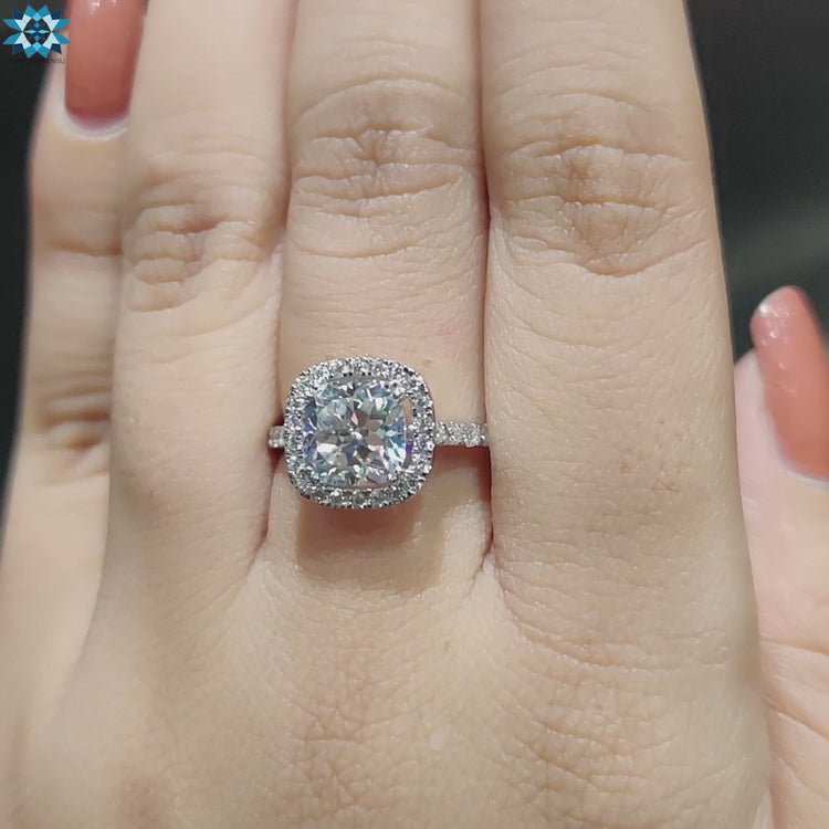 Handmade ring crafted in white gold with halo cushion moissanite.
