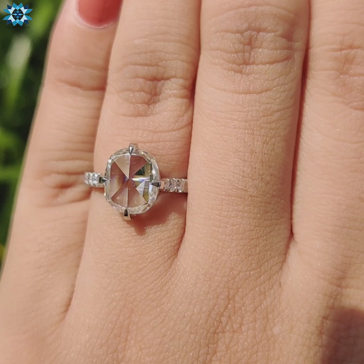 Cushion cut moissanite ring with hidden halo and claw prongs.
