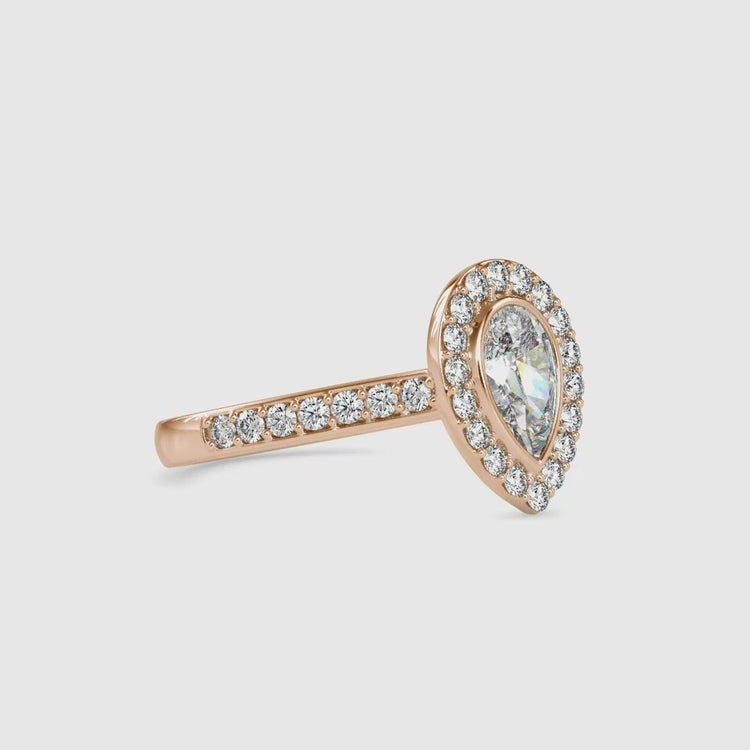 Handmade ring featuring bezel setting and pear cut diamond.