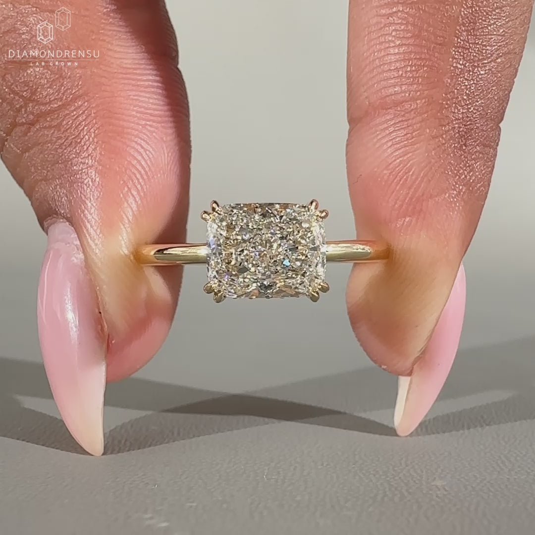 Elongated cushion cut ring in yellow gold for engagement.
