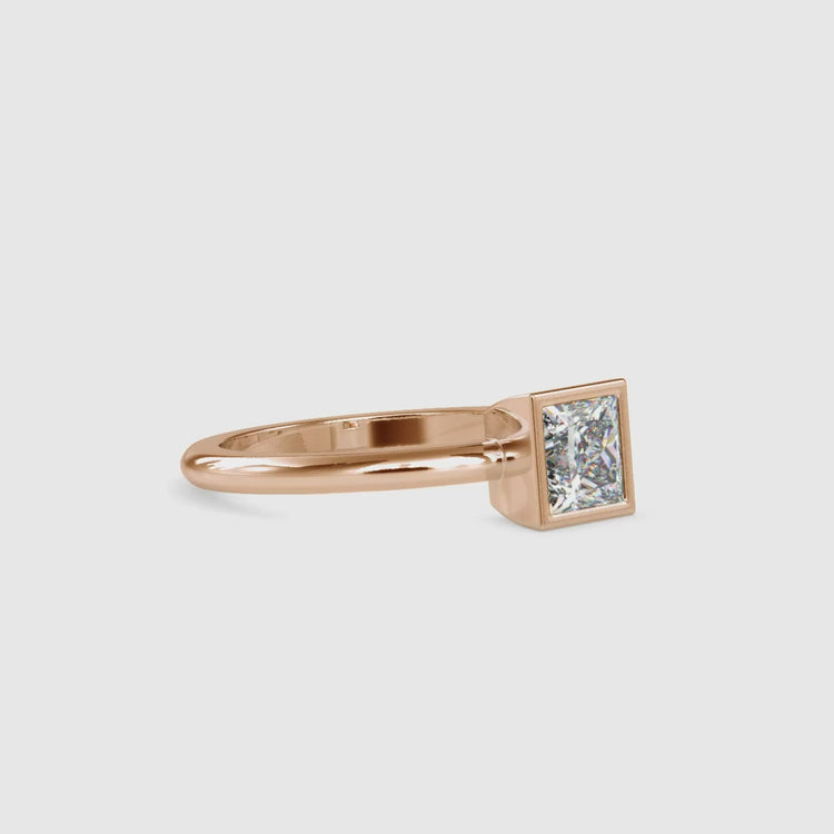 Yellow gold engagement ring with handmade bezel princess diamond.
