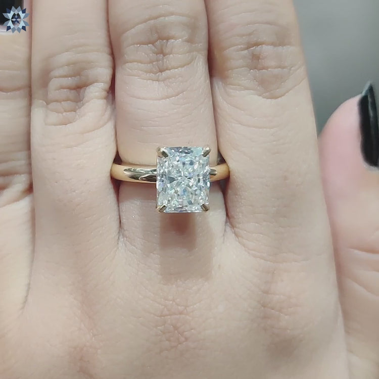 Elegant radiant cut solitaire engagement ring made in yellow gold.

