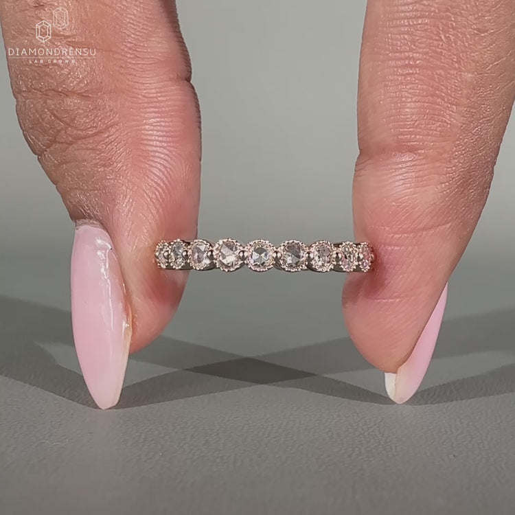 Eternity wedding band featuring lab grown diamonds in a rose cut style.
