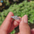Four stone engagement ring with white gold band and moissanite center.
