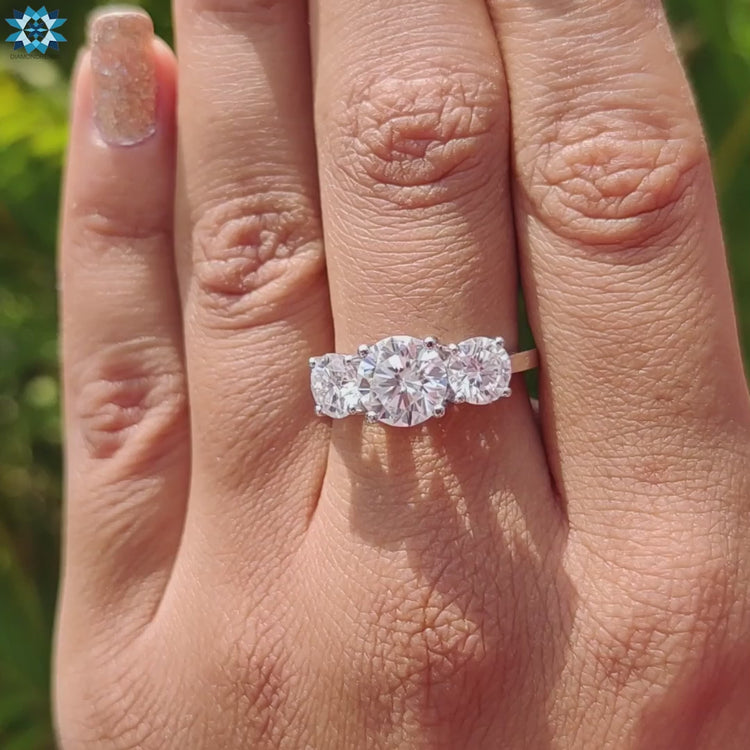 Custom round engagement ring with three stone detail.
