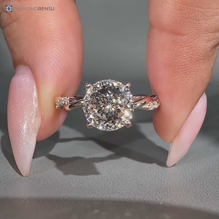Portuguese cut diamond ring with round diamond pavé style.