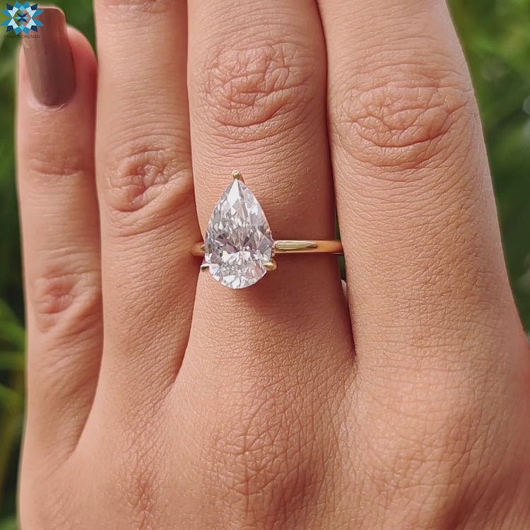 Handmade jewelry with pear shaped moissanite and hidden halo.
