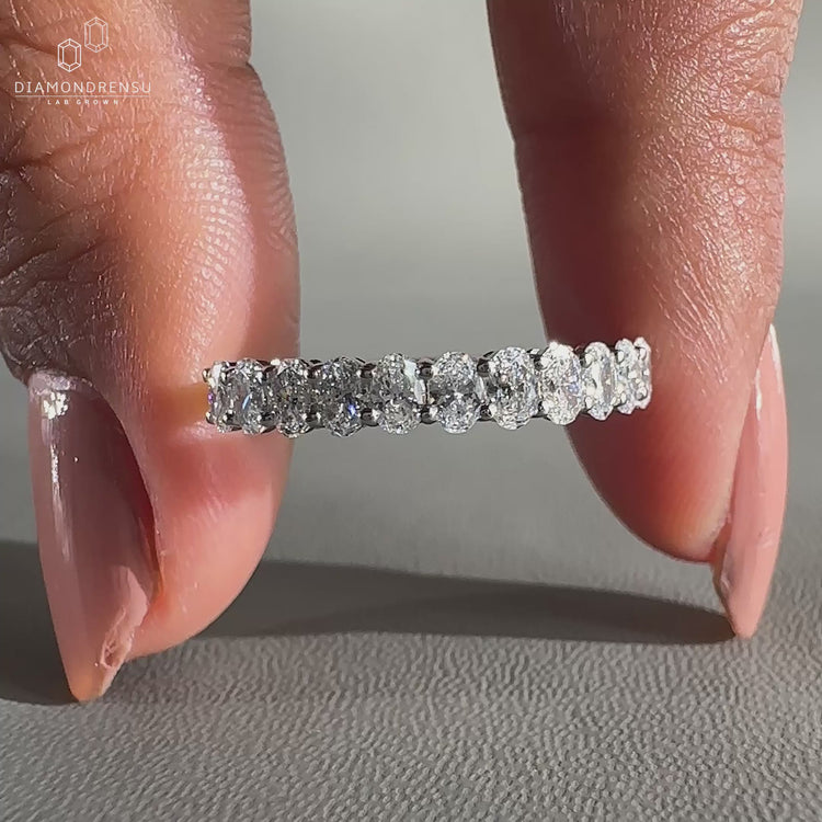 Half eternity diamond band featuring lab grown oval cut stones.