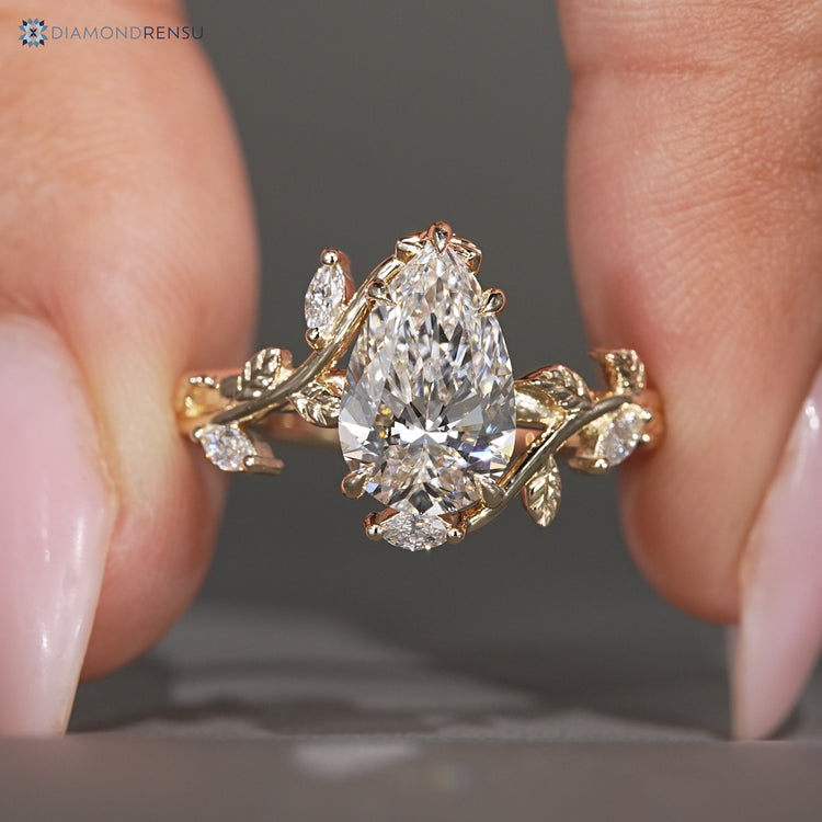 Nature inspired pear cut diamond ring with bypass setting.