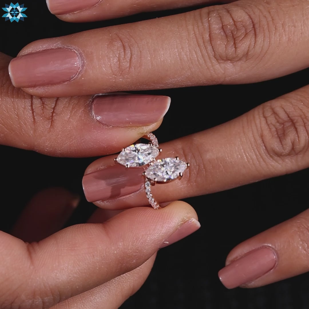 Marquise cut moissanite ring crafted in rose gold with round cut pave band.

