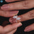 Marquise cut moissanite ring crafted in rose gold with round cut pave band.
